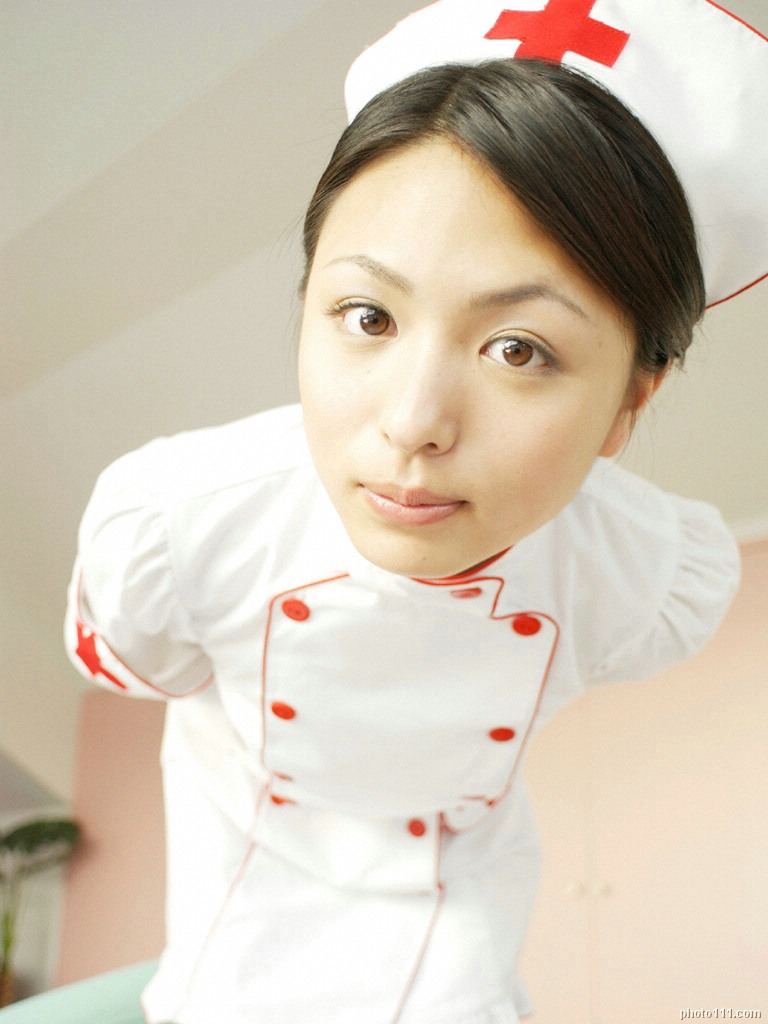 kawamura yuki, photo (medium), tagme, 1girl, asian, breasts, cosplay, female focus, hat, indoors, leaning forward, looking at viewer, medium breasts, nurse, nurse cap, solo