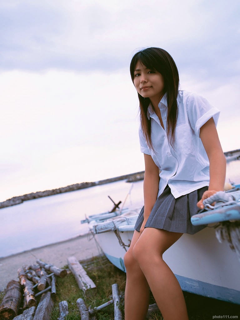 kawamura yuki, photo (medium), tagme, 1girl, asian, bare legs, boat, dutch angle, female focus, long hair, looking at viewer, ocean, outdoors, pleated skirt, skirt, solo, watercraft