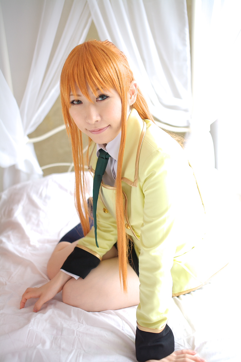 chippi, shirley fenette, code geass, highres, photo (medium), 1girl, asian, bed, bedroom, blazer, blue eyes, color contacts, cosplay, female focus, indoors, jacket, kneehighs, long hair, looking at viewer, miniskirt, orange hair, school uniform, shirley fenette (cosplay), sitting, skirt, socks, solo, yokozuwari
