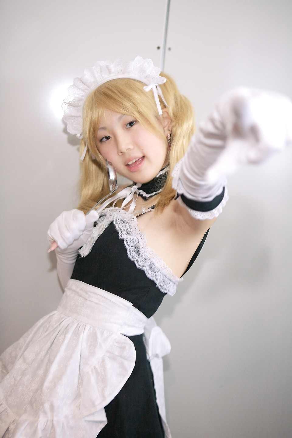 hime (cosplayer), sawatari izumi, kore ga watashi no goshujin-sama, highres, photo (medium), 1girl, apron, armpits, asian, bare shoulders, blonde hair, blurry, cosplay, depth of field, detached collar, earrings, elbow gloves, female focus, gloves, indoors, japanese (nationality), jewelry, ladle, looking at viewer, maid, maid apron, maid headdress, nakabayashi yoshitaka's maid uniform, sawatari izumi (cosplay), solo, twintails, waist apron, white gloves