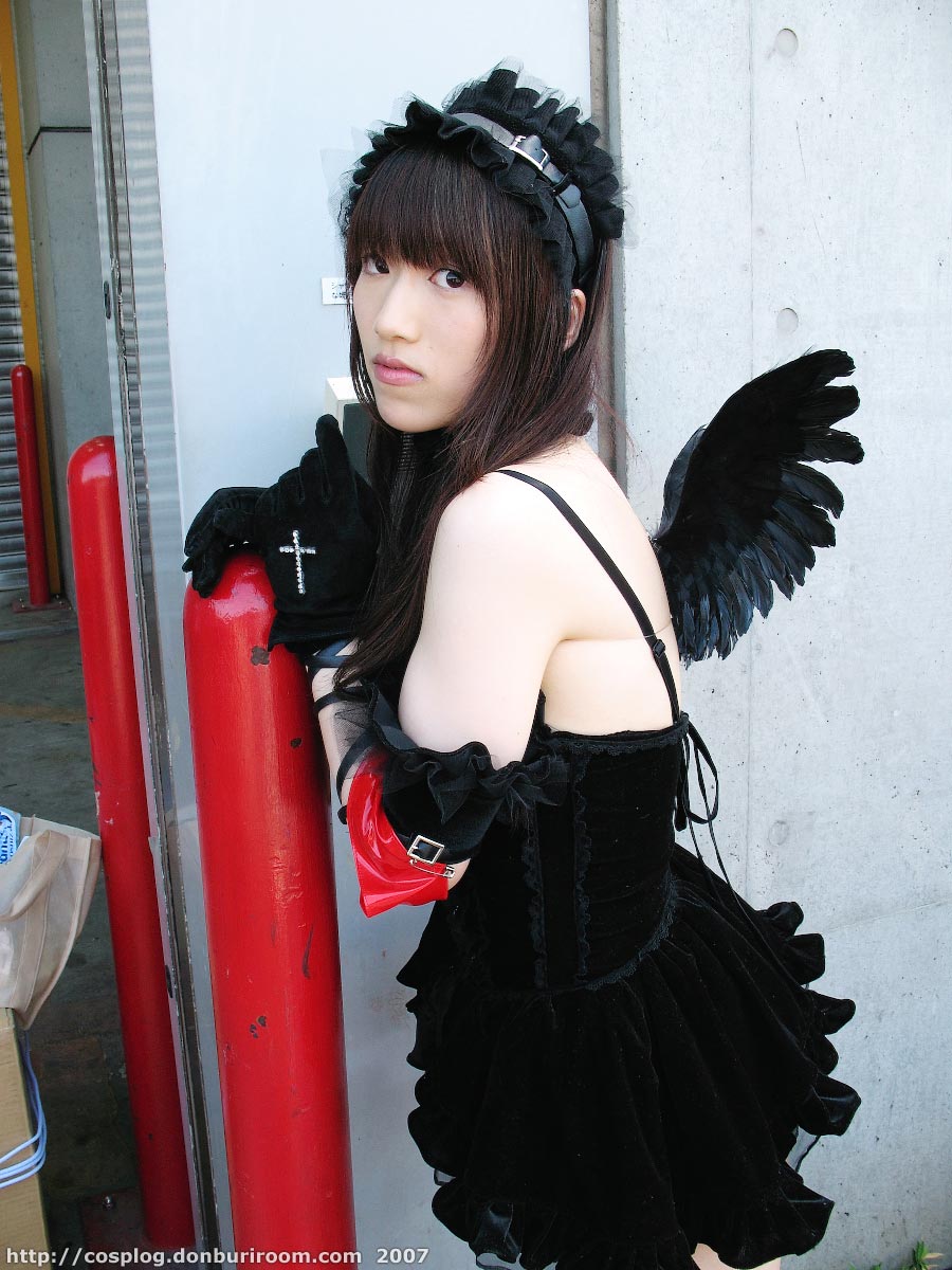 suzuyuki kaho, morte (vispo), vispo original, highres, photo (medium), tagme, 1girl, 2007, apron, arm laces, armband, asian, bare shoulders, black dress, black gloves, collar, cosplay, cross, dress, female focus, gloves, gothic lolita, hairband, japanese (nationality), lolita fashion, lolita hairband, looking at viewer, maid, maid apron, outdoors, short dress, solo, watermark, web address, wings