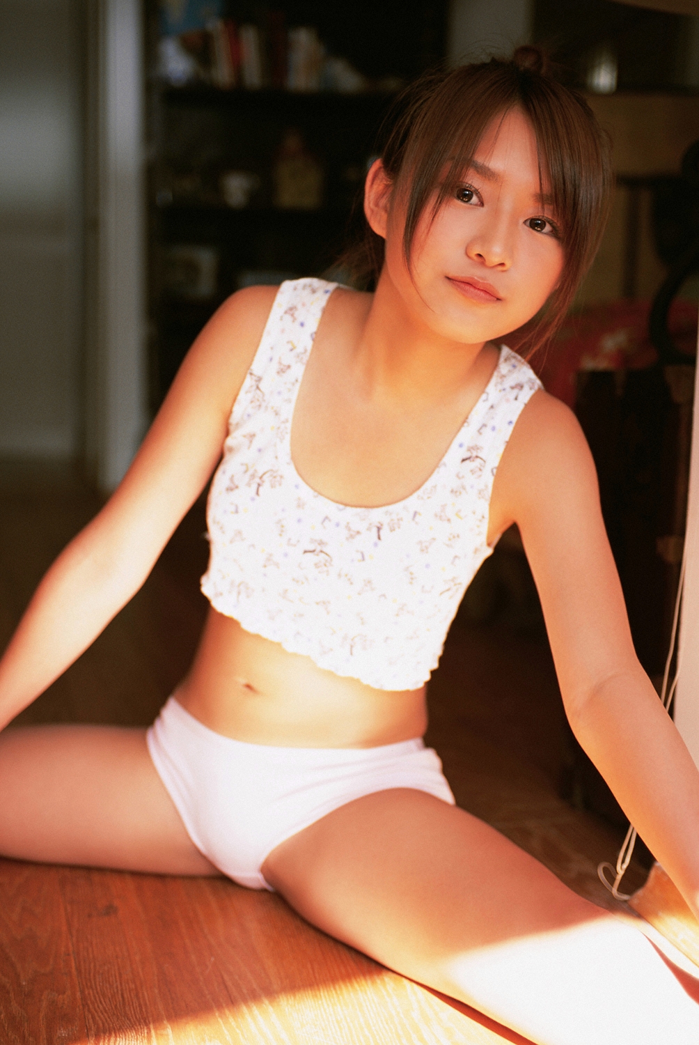 kamata natsumi, highres, photo (medium), 1girl, asian, blurry, blurry background, brown eyes, brown hair, closed mouth, crop top, day, female focus, indoors, looking at viewer, midriff, navel, on floor, panties, shirt, shorts, sitting, sleeveless, sleeveless shirt, solo, spread legs, stretching, sunlight, swept bangs, tank top, underwear, white panties