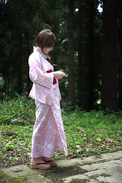 kouya (model), photo (medium), tagme, 1girl, dress, female focus, floral print, japanese clothes, kimono, lace, lace-trimmed dress, lace trim, obi, outdoors, pink dress, platform sandals, print dress, print kimono, sandals, sash, side ponytail, solo, standing, tree, yukata