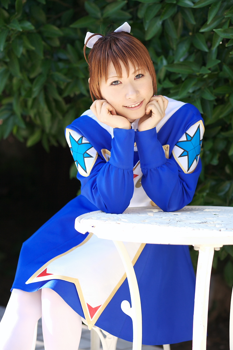 chippi, arika yumemiya, my-otome, white legwear, highres, photo (medium), 1girl, arika yumemiya (cosplay), asian, blue eyes, blurry, braid, color contacts, cosplay, depth of field, female focus, long hair, looking at viewer, outdoors, school uniform, sitting, smile, solo, table, twin braids, ultimate blue sky