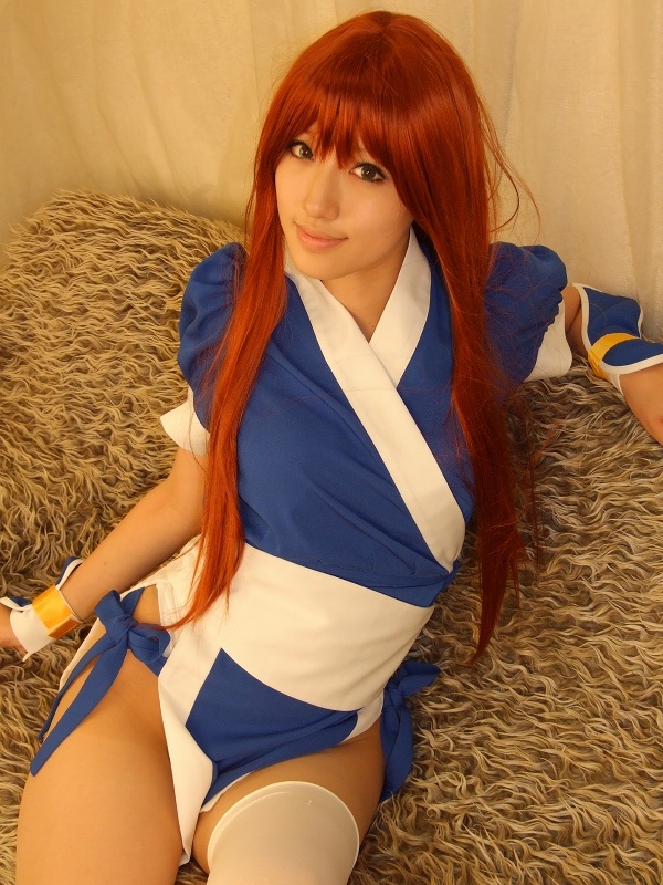 saya (cosplayer), kasumi (doa), dead or alive, tecmo, photo (medium), 1girl, asian, cosplay, couch, curtains, female focus, indoors, kasumi (doa) (cosplay), long hair, looking at viewer, ninja, pelvic curtain, red hair, sitting, solo, thighhighs, white thighhighs