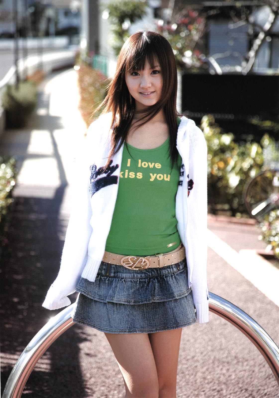 hamada shoko, highres, photo (medium), 1girl, asian, denim, denim skirt, english text, engrish text, female focus, jacket, long hair, looking at viewer, miniskirt, outdoors, ranguage, skirt, solo, tank top