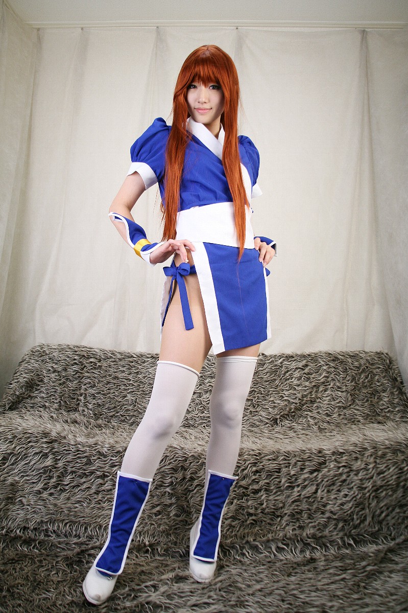 saya (cosplayer), kasumi (doa), dead or alive, tecmo, highres, photo (medium), 1girl, asian, cosplay, couch, curtains, female focus, indoors, kasumi (doa) (cosplay), long hair, looking at viewer, ninja, pelvic curtain, red hair, solo, thighhighs, white thighhighs