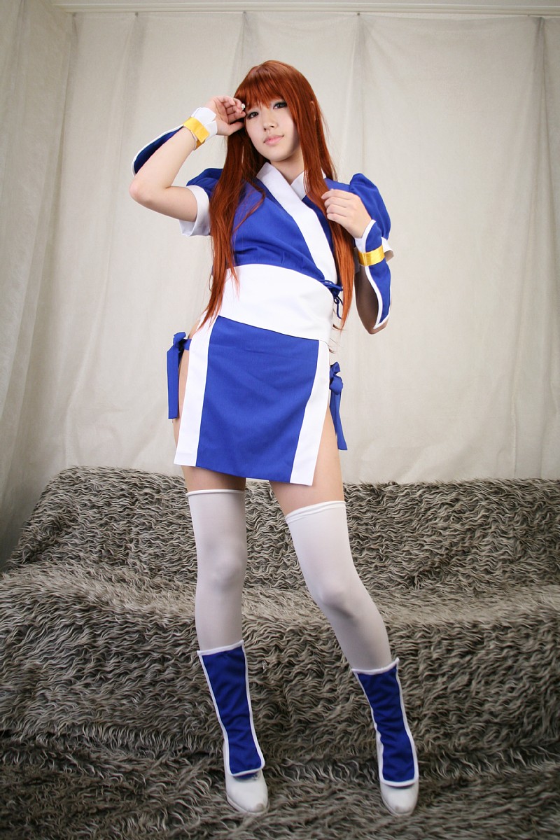 saya (cosplayer), kasumi (doa), dead or alive, tecmo, highres, photo (medium), 1girl, asian, cosplay, couch, curtains, female focus, indoors, kasumi (doa) (cosplay), long hair, looking at viewer, ninja, pelvic curtain, red hair, solo, thighhighs, white thighhighs