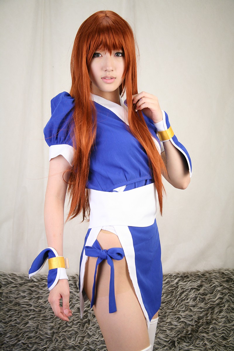 saya (cosplayer), kasumi (doa), dead or alive, tecmo, highres, photo (medium), 1girl, asian, cosplay, couch, curtains, female focus, indoors, kasumi (doa) (cosplay), long hair, looking at viewer, ninja, pelvic curtain, red hair, solo, thighhighs, white thighhighs