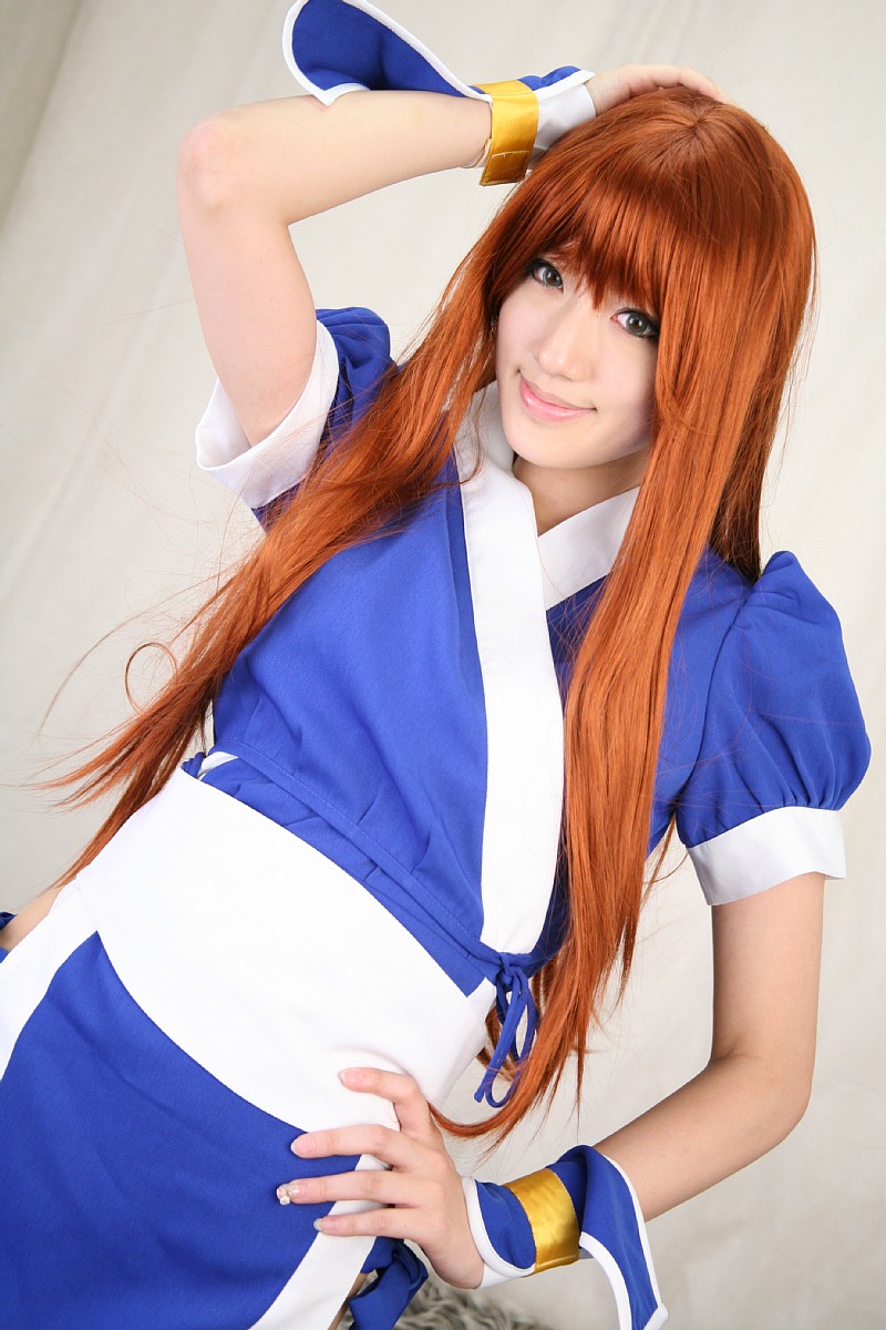 saya (cosplayer), kasumi (doa), dead or alive, tecmo, highres, photo (medium), 1girl, asian, cosplay, couch, curtains, dutch angle, female focus, indoors, kasumi (doa) (cosplay), long hair, looking at viewer, ninja, pelvic curtain, red hair, smile, solo