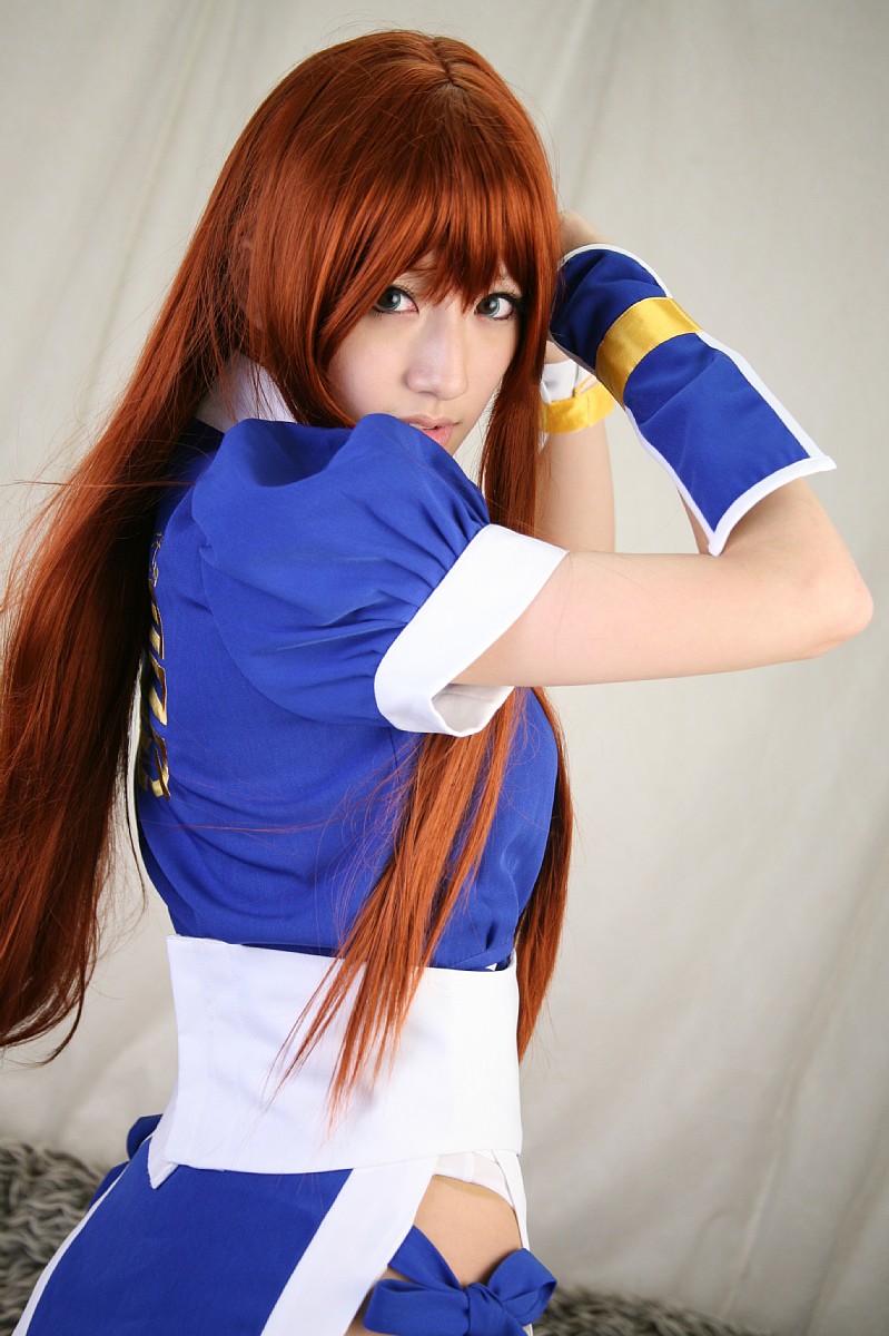 saya (cosplayer), kasumi (doa), dead or alive, tecmo, white legwear, highres, photo (medium), 1girl, asian, cosplay, couch, curtains, female focus, indoors, kasumi (doa) (cosplay), long hair, looking at viewer, ninja, pelvic curtain, red hair, solo
