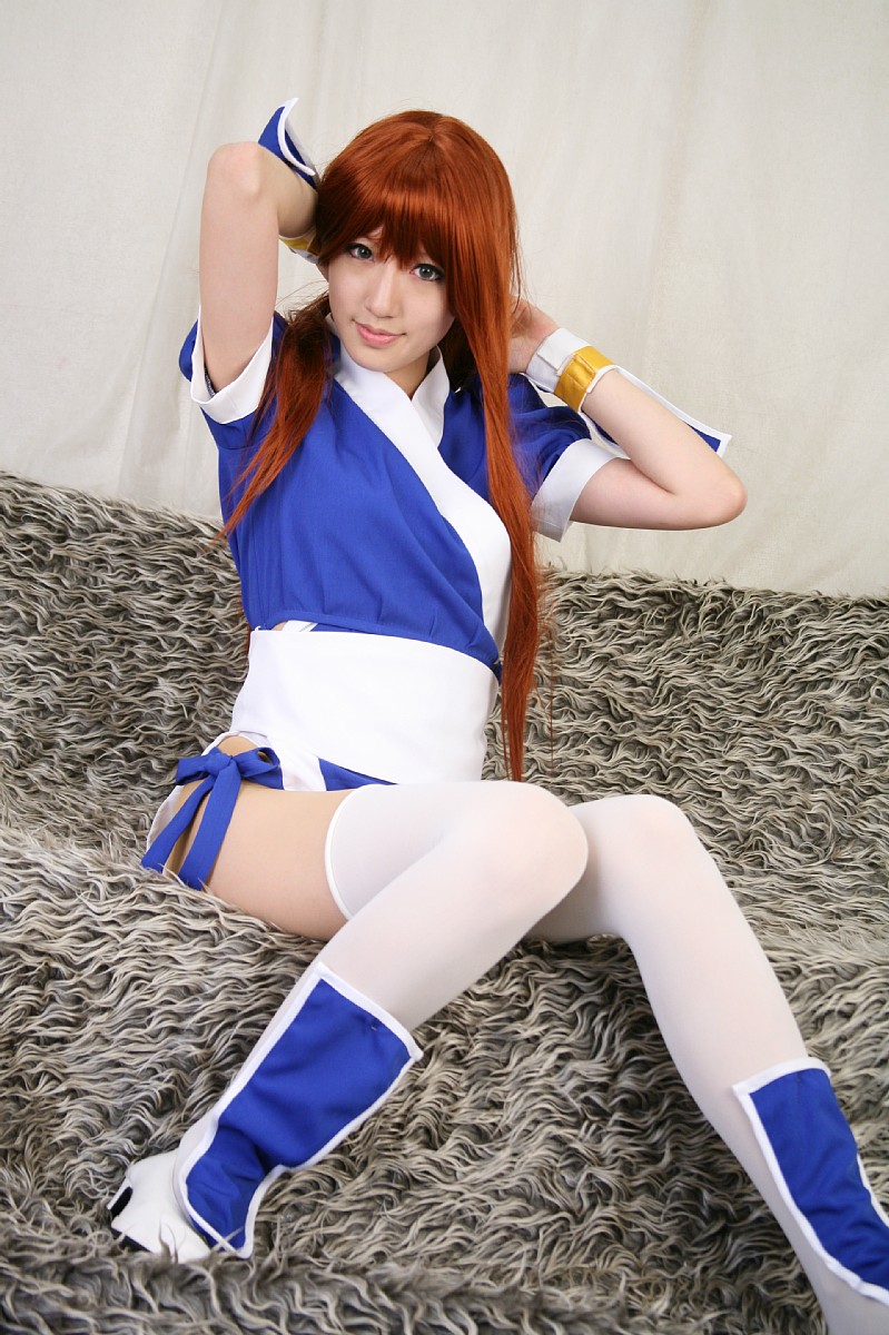 saya (cosplayer), kasumi (doa), dead or alive, tecmo, highres, photo (medium), 1girl, asian, cosplay, couch, curtains, female focus, indoors, kasumi (doa) (cosplay), long hair, looking at viewer, ninja, pelvic curtain, red hair, solo, thighhighs, white thighhighs