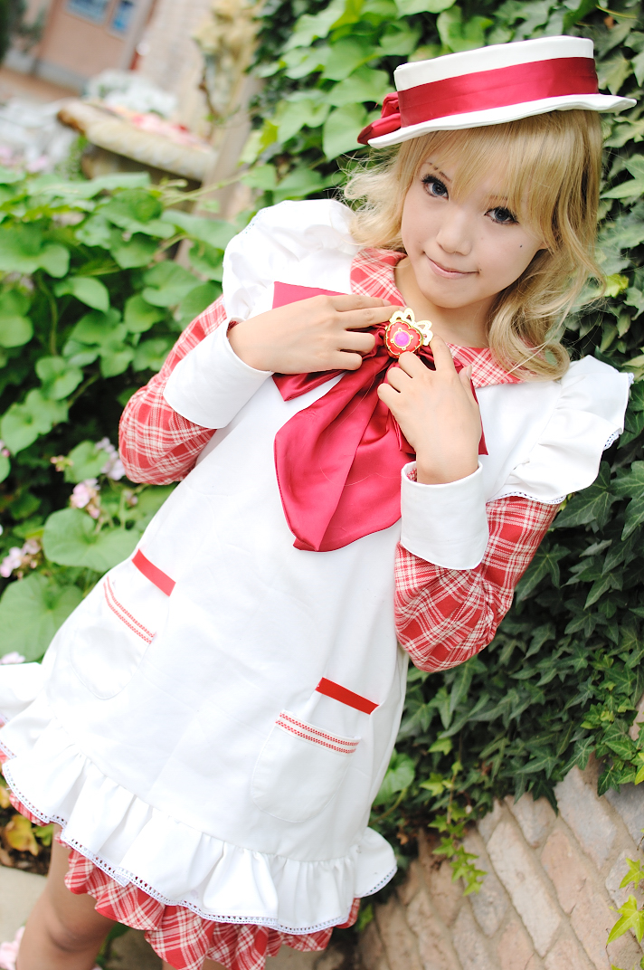 kipi-san, nadja applefield, ashita no nadja, photo (medium), 1girl, apron, asian, blonde hair, blurry, boater hat, bow, cosplay, depth of field, dutch angle, female focus, frills, long hair, looking at viewer, mole, nadja applefield (cosplay), outdoors, solo, standing