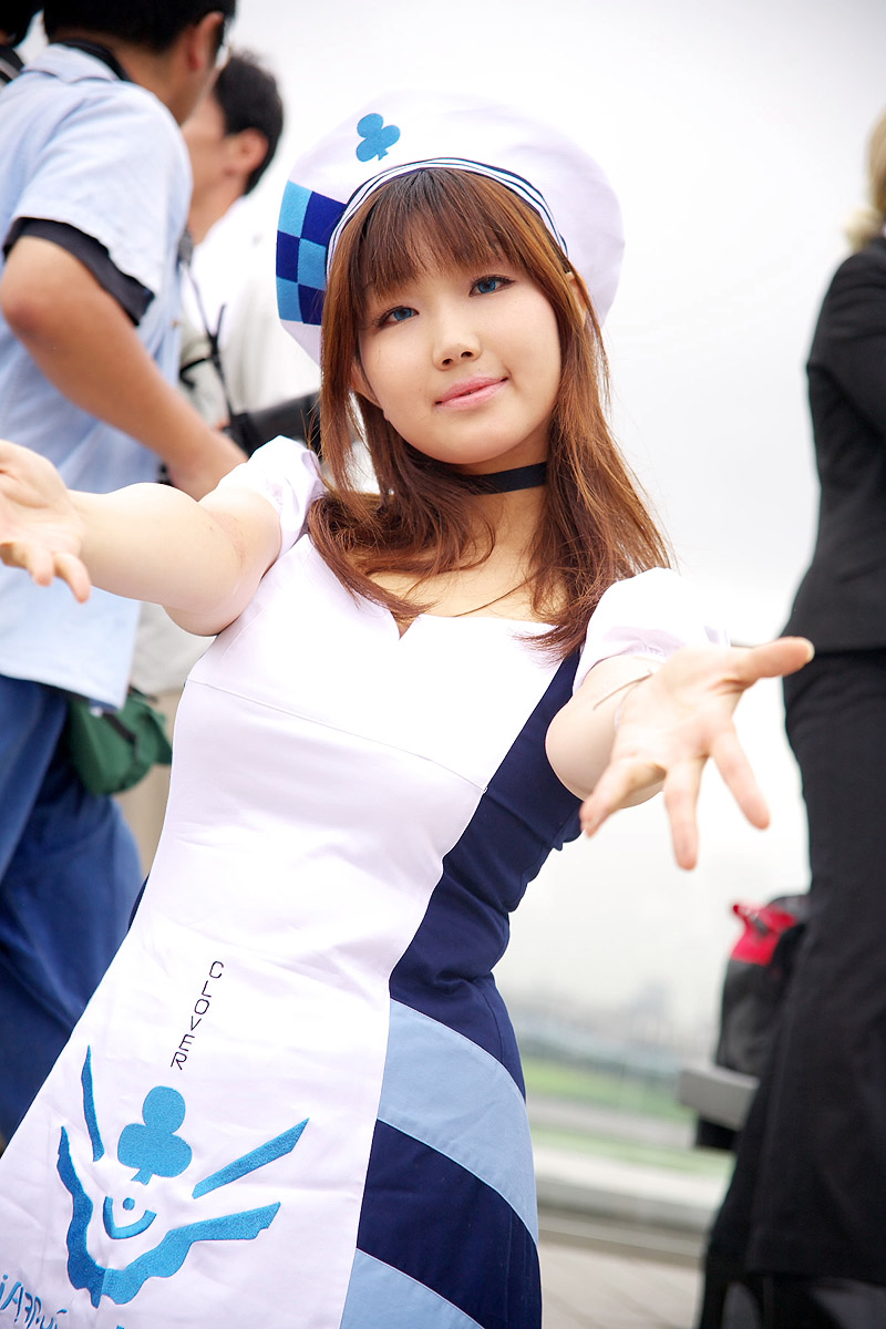 arin (pangya), pangya, artist request, highres, photo (medium), 1girl, asian, beret, black choker, blurry, brown hair, choker, cosplay, depth of field, dress, dutch angle, dyed hair, hat, long hair, looking at viewer, outdoors, outstretched arms, short sleeves, solo focus