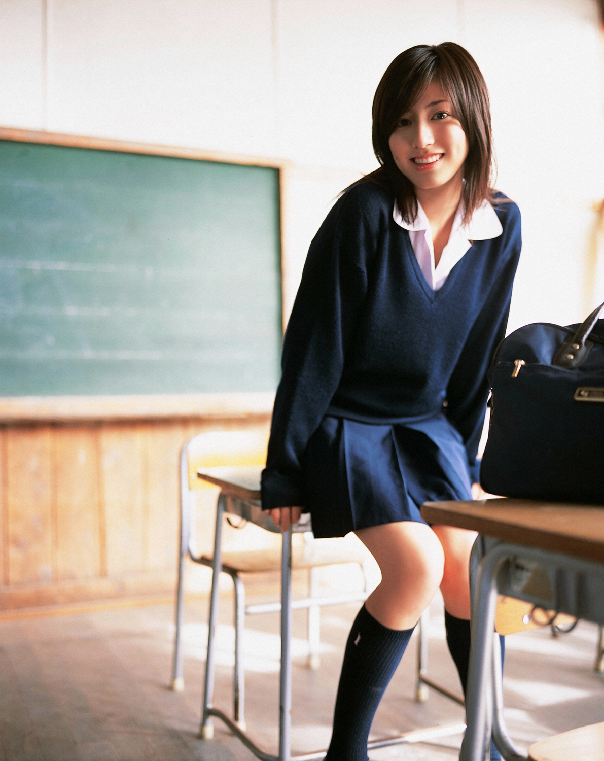 sugimoto yumi, highres, photo (medium), 1girl, asian, brown hair, cosplay, female focus, indoors, kneehighs, long hair, looking at viewer, miniskirt, pleated skirt, school uniform, skirt, socks, solo, sweater