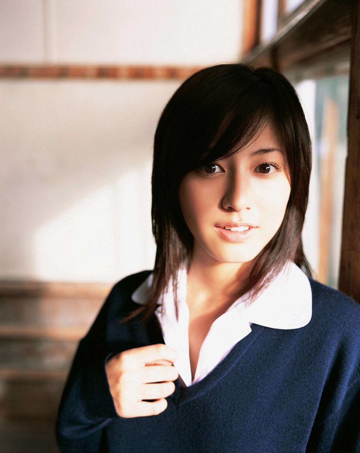 sugimoto yumi, highres, photo (medium), 1girl, asian, brown hair, classroom, cosplay, female focus, indoors, long hair, looking at viewer, miniskirt, pleated skirt, school, school uniform, skirt, solo, sweater