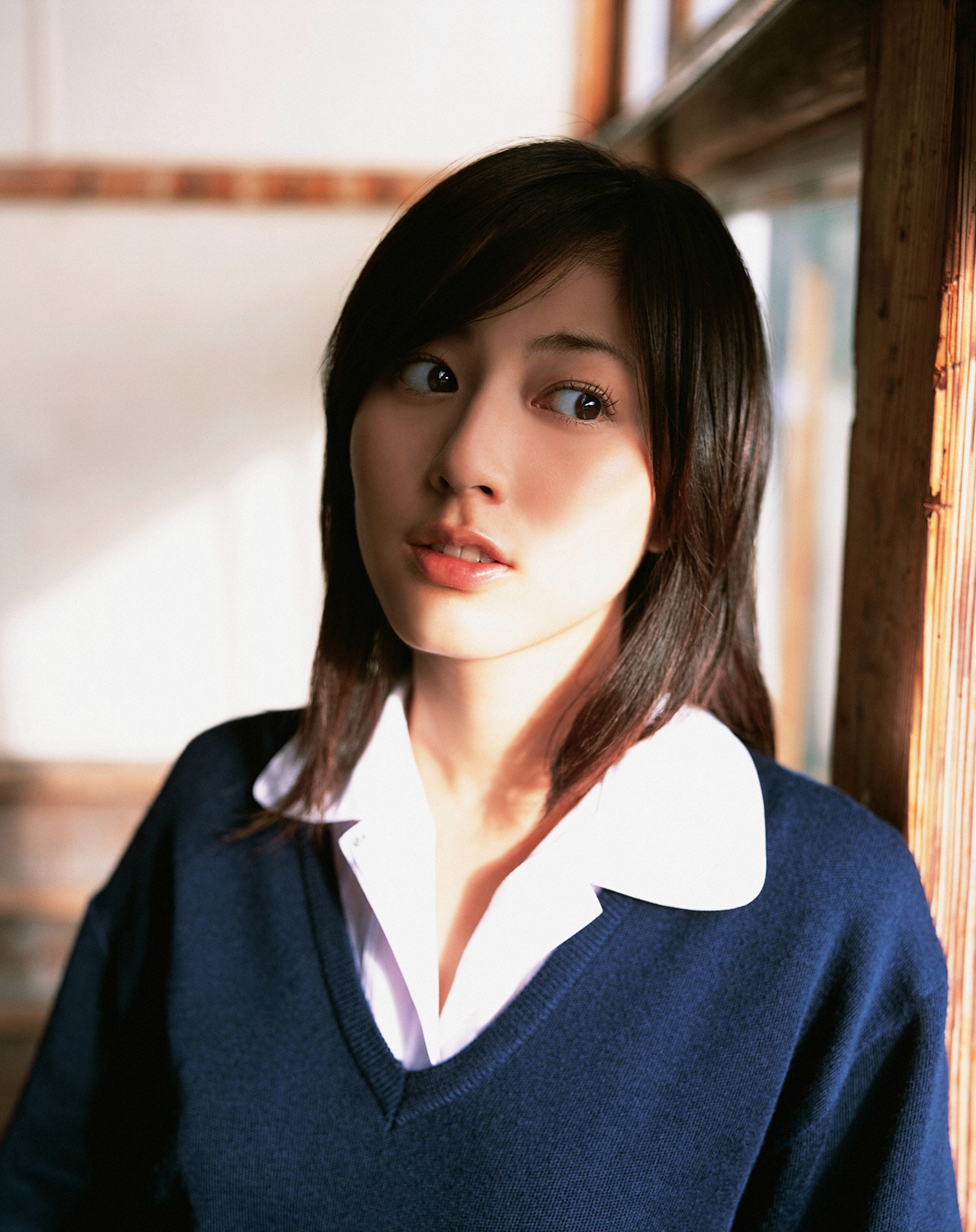 sugimoto yumi, highres, photo (medium), 1girl, asian, brown hair, classroom, cosplay, female focus, indoors, long hair, looking at viewer, miniskirt, pleated skirt, school, school uniform, skirt, solo, sweater