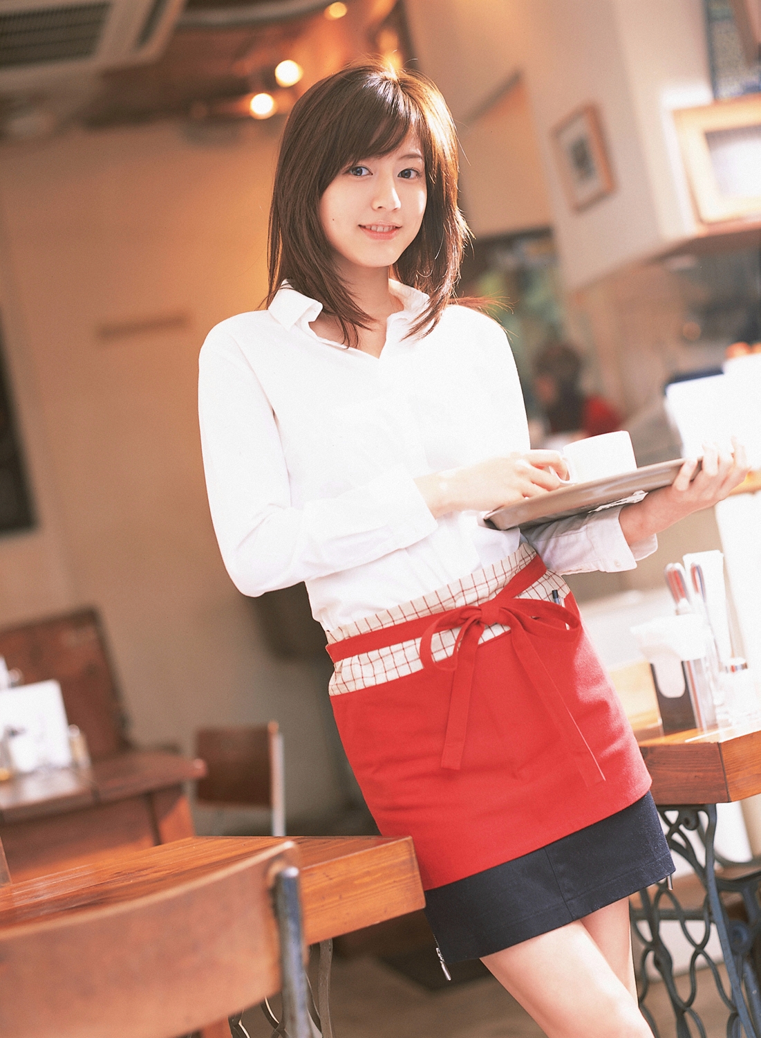sugimoto yumi, highres, photo (medium), 1girl, apron, asian, brown hair, cosplay, dutch angle, female focus, indoors, long hair, looking at viewer, miniskirt, skirt, solo, tray, waitress