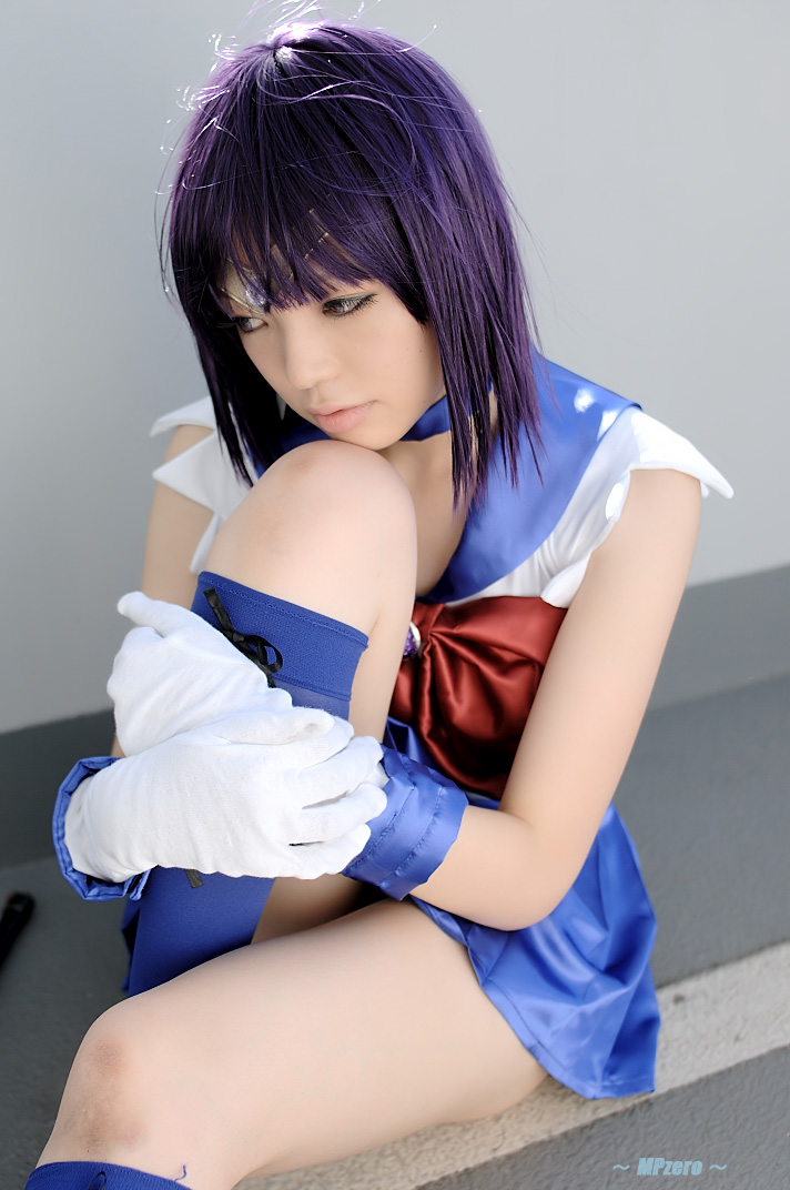 namada, sailor saturn, tomoe hotaru, bishoujo senshi sailor moon, looking away, photo (medium), 1girl, asian, blue boots, blue choker, blue skirt, boots, bow, breasts, brooch, choker, circlet, cosplay, female focus, gloves, hugging own legs, jewelry, magical girl, miniskirt, on floor, outdoors, pantyhose, parted lips, pleated skirt, purple hair, railing, red bow, ribbon, sailor saturn (cosplay), school uniform, serafuku, shirt, short hair, sitting, skirt, sleeveless, small breasts, solo, white gloves, white shirt