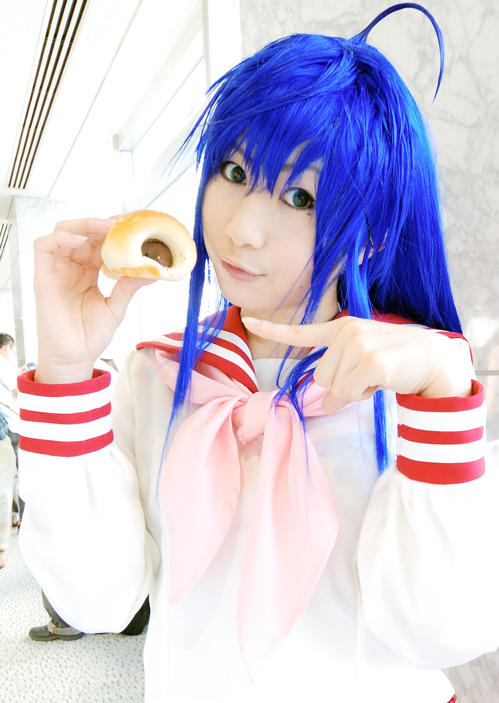 kochou ran, izumi konata, lucky star, highres, photo (medium), 1girl, :3, ahoge, blue hair, chocolate cornet, cosplay, female focus, food, izumi konata (cosplay), sailor, school uniform, serafuku