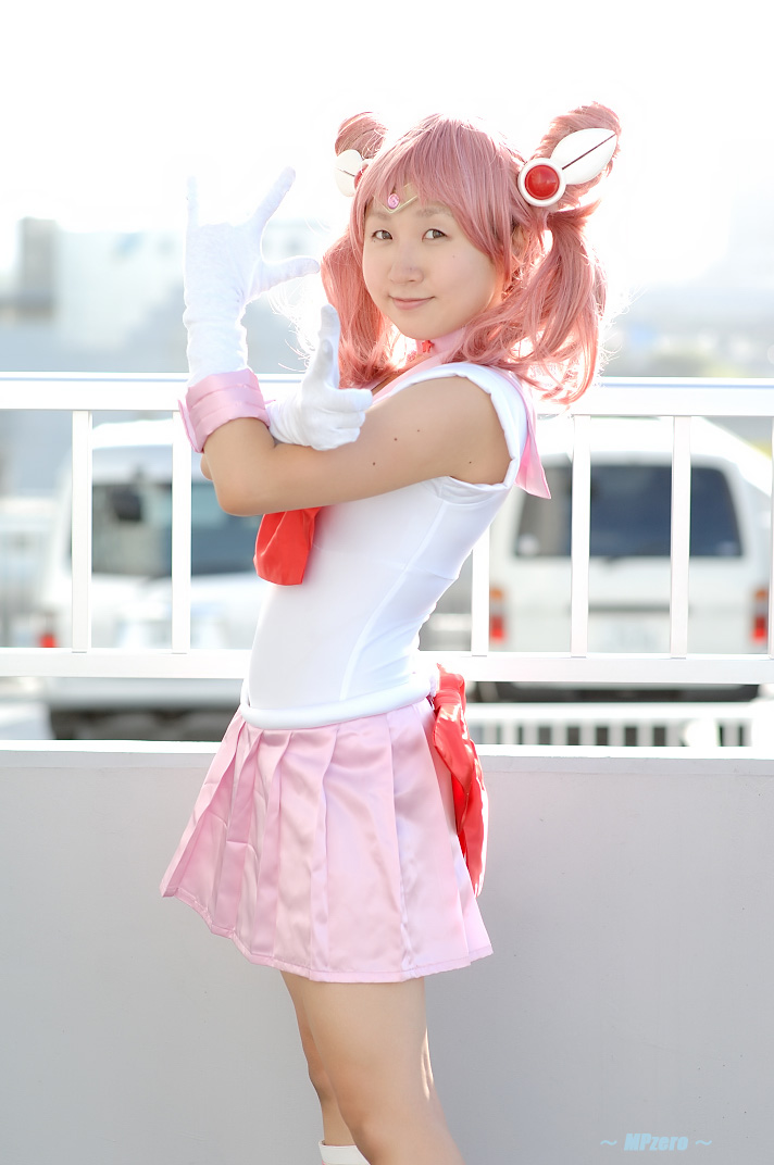 miasa, chibi usa, sailor chibi moon, bishoujo senshi sailor moon, photo (medium), 1girl, asian, boots, brown eyes, cosplay, female focus, gloves, looking at viewer, m/, mole, mole under eye, outdoors, pink hair, pointing, pointing at viewer, sailor, sailor chibi moon (cosplay), school uniform, serafuku, solo, standing, twintails, white gloves