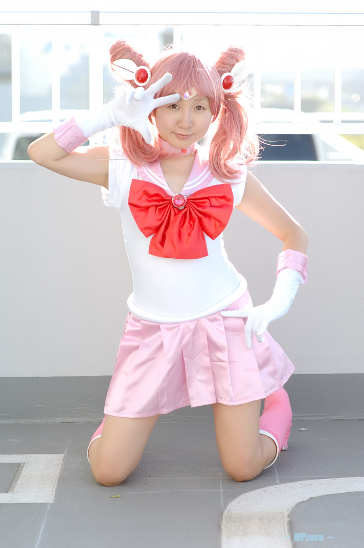miasa, chibi usa, sailor chibi moon, bishoujo senshi sailor moon, photo (medium), 1girl, asian, boots, brown eyes, cosplay, female focus, gloves, hand on own hip, kneeling, looking at viewer, mole, mole under eye, outdoors, pink hair, sailor, sailor chibi moon (cosplay), school uniform, serafuku, solo, twintails, v, white gloves