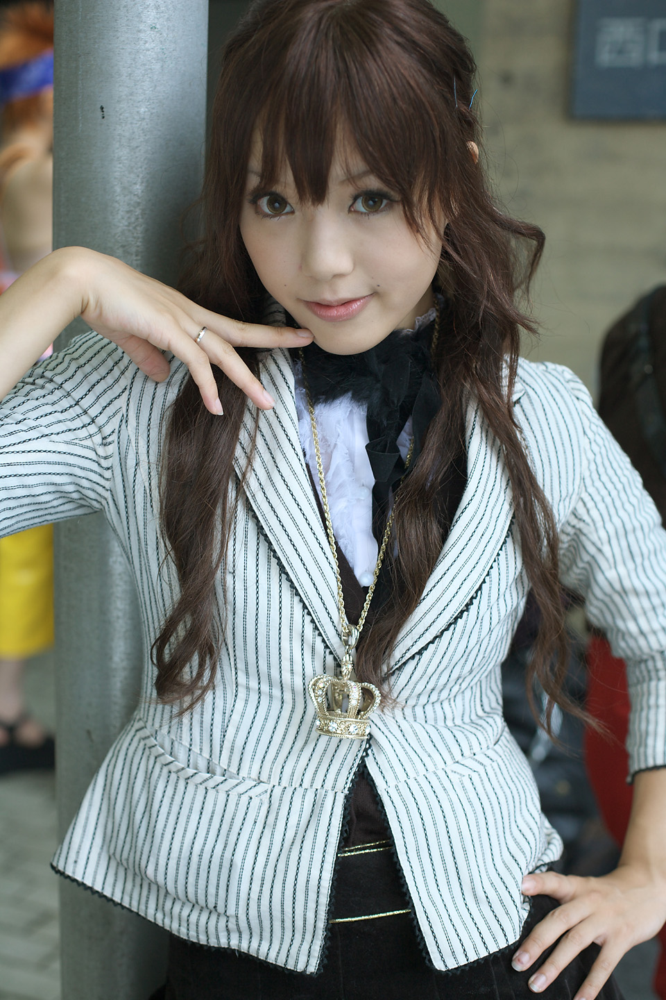 kipi-san, highres, photo (medium), 1girl, asian, blazer, bling, brown eyes, brown hair, female focus, hair ornament, hairclip, hand on own hip, indoors, jacket, jewelry, long hair, looking at viewer, mole, necklace, pendant, ring, solo