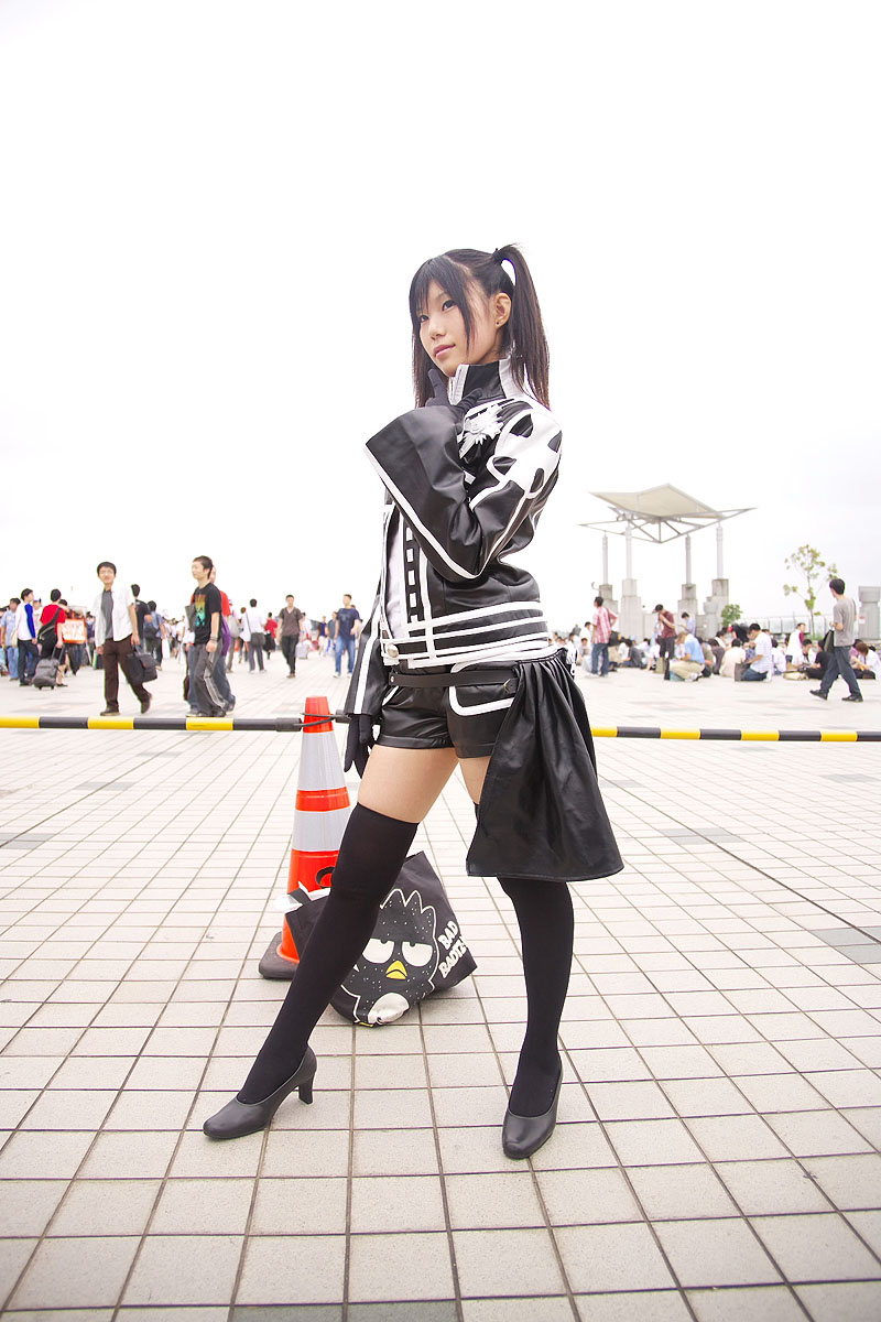 rubia, lenalee lee, d.gray-man, black footwear, highres, photo (medium), 1girl, 6+boys, black gloves, black hair, black thighhighs, cosplay, gloves, lenalee lee (cosplay), multiple boys, outdoors, shoes, shorts, solo focus, thighhighs, traffic cone, twintails, zettai ryouiki