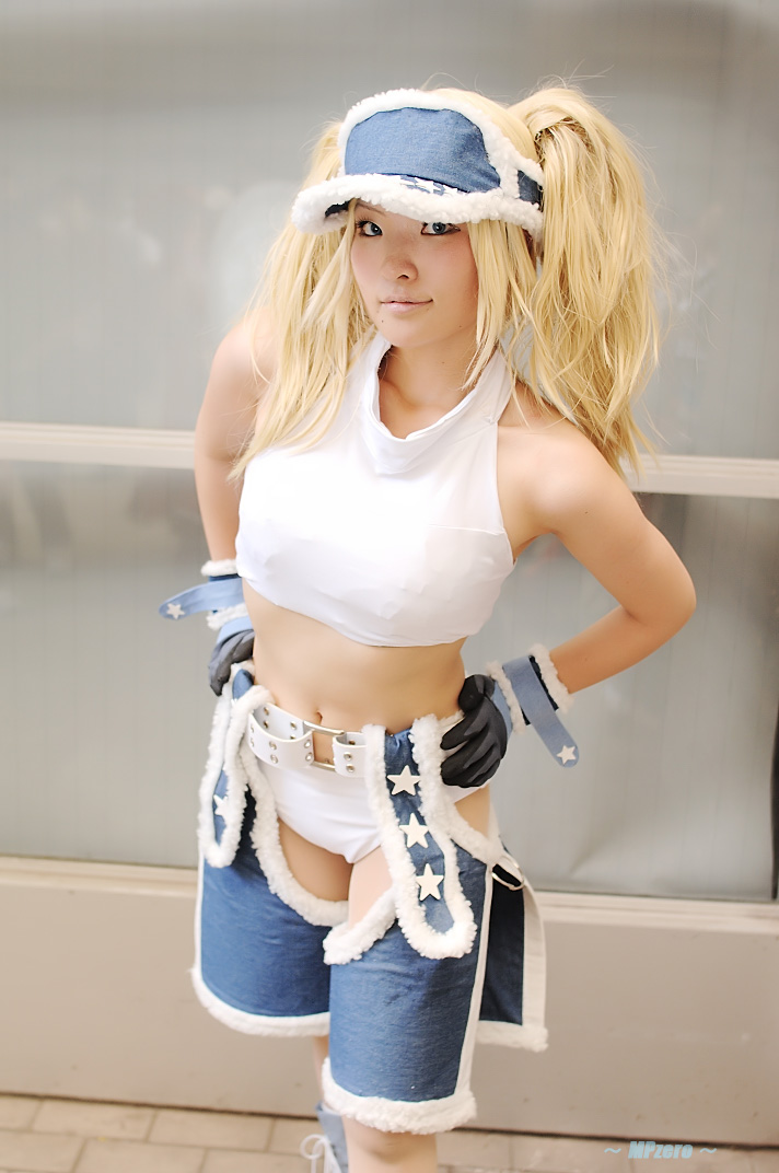 nogu, blue mary, kof: maximum impact, snk, the king of fighters, photo (medium), 1girl, blonde hair, blue eyes, chaps, cosplay, female focus, gloves, halterneck, long hair, midriff, solo, twintails