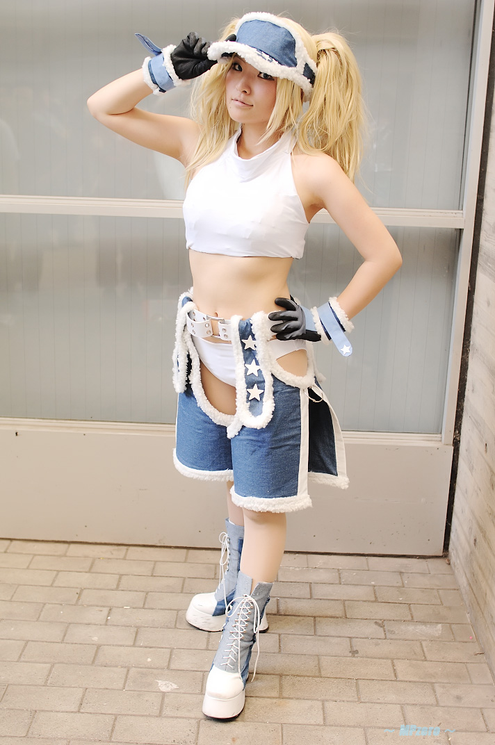 nogu, blue mary, kof: maximum impact, snk, the king of fighters, photo (medium), 1girl, blonde hair, blue eyes, chaps, cosplay, female focus, gloves, halterneck, long hair, midriff, solo, twintails