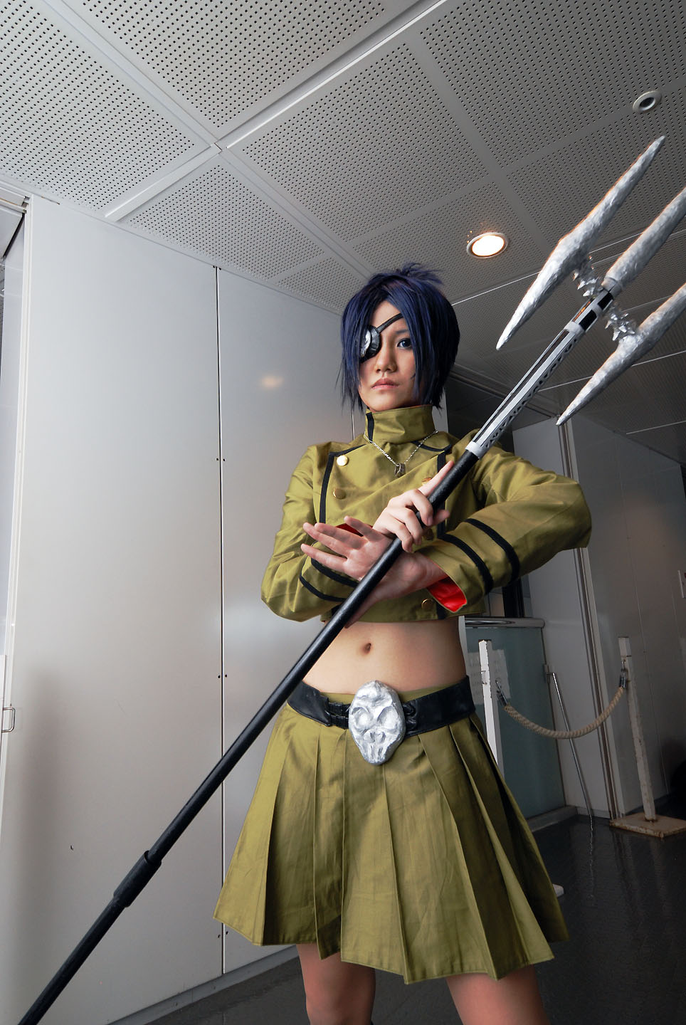 isumi (i-spixi), chrome dokuro, katekyo hitman reborn!, highres, photo (medium), 1girl, blue hair, boots, cosplay, eyepatch, female focus, indoors, midriff, pleated skirt, polearm, skirt, solo, spear, trident, weapon