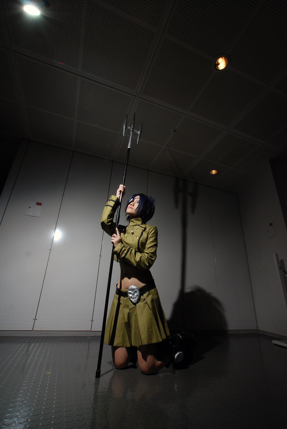 isumi (i-spixi), chrome dokuro, katekyo hitman reborn!, highres, photo (medium), 1girl, blue hair, boots, cosplay, eyepatch, female focus, full body, indoors, midriff, pleated skirt, polearm, skirt, solo, spear, trident, weapon
