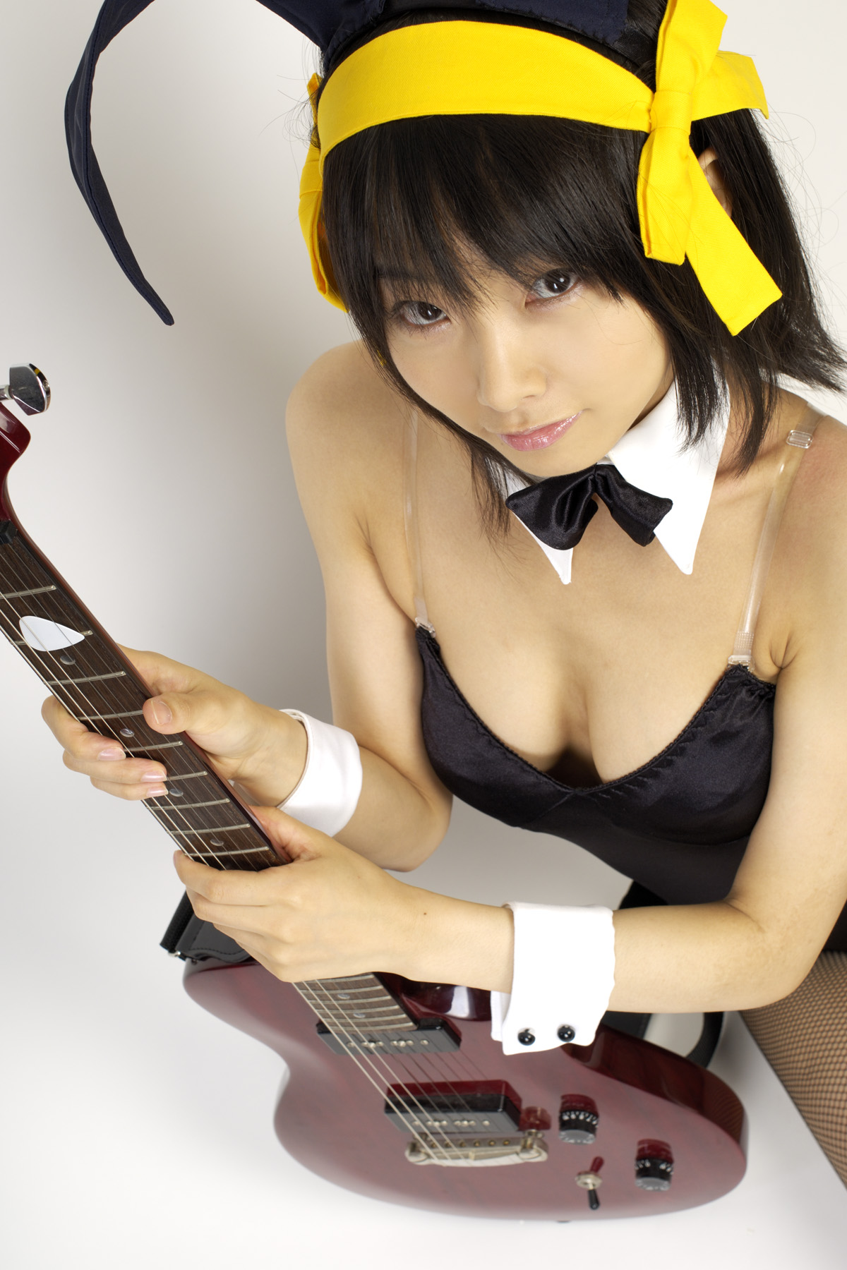 matsunaga ayaka, suzumiya haruhi, suzumiya haruhi no yuuutsu, fishnet legwear, highres, photo (medium), animal ears, cosplay, fishnets, guitar, hair ribbon, instrument, leotard, rabbit ears, ribbon