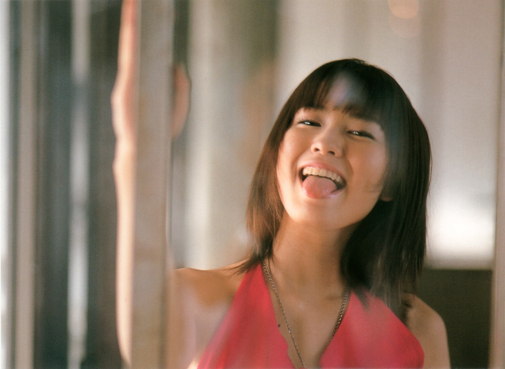 ichikawa yui, photo (medium), 1girl, :p, asian, brown hair, female focus, halterneck, indoors, long hair, looking at viewer, smile, solo, tongue, tongue out