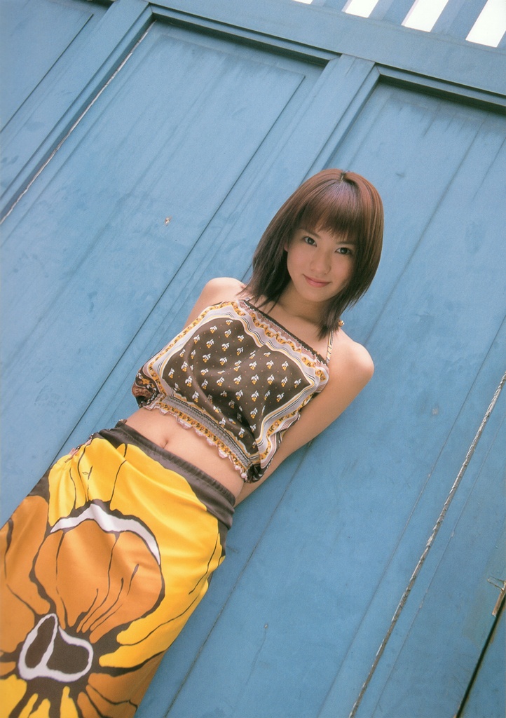 ichikawa yui, photo (medium), 1girl, asian, brown hair, dutch angle, female focus, halterneck, looking at viewer, midriff, skirt, smile, solo