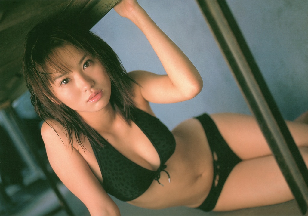 ichikawa yui, photo (medium), 1girl, animal print, arm support, asian, bikini, black bikini, brown hair, dutch angle, female focus, front-tie bikini top, front-tie top, indoors, leopard print, looking at viewer, mole, on floor, sitting, solo, swimsuit, table, under table, yokozuwari