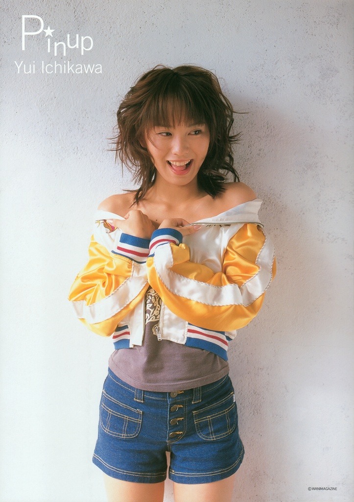 ichikawa yui, photo (medium), 1girl, artist name, asian, brown hair, denim, denim shorts, female focus, indoors, jacket, mole, off shoulder, shirt, shorts, smile, solo, t-shirt