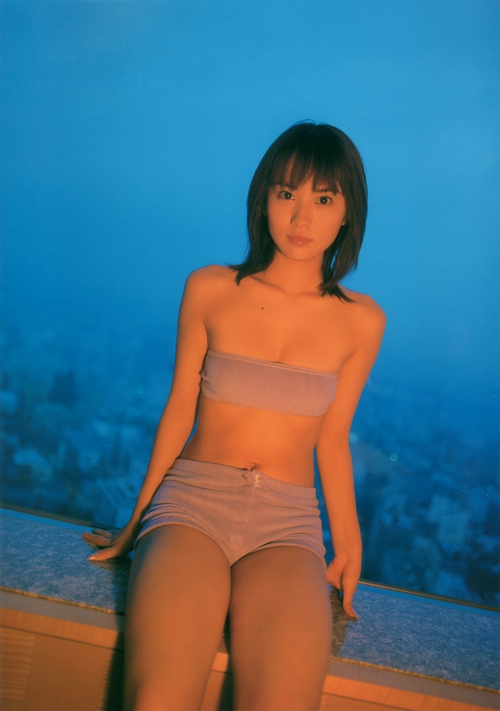 ichikawa yui, photo (medium), tagme, 1girl, asian, bare shoulders, breasts, brown hair, cowboy shot, dutch angle, facing viewer, female focus, japanese (nationality), looking at viewer, midriff, mole, outdoors, shorts, sitting, small breasts, solo, strapless, tube top, window
