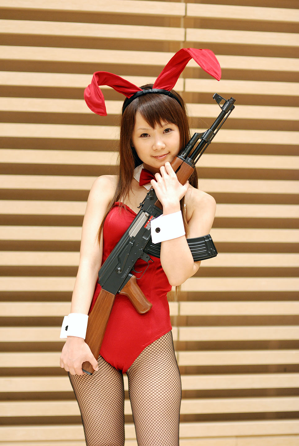 hiromichi, asahina mikuru, suzumiya haruhi no yuuutsu, fishnet legwear, highres, photo (medium), ak-47, animal ears, assault rifle, collar, cosplay, fishnets, gun, kalashnikov, kalashnikov rifle, leotard, rabbit ears, rifle, weapon