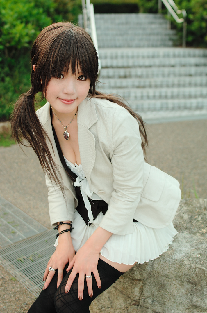 kipi-san, hands on thighs, photo (medium), 1girl, asian, blazer, breasts, brown eyes, brown hair, brown nails, cleavage, female focus, jacket, jewelry, long hair, looking at viewer, miniskirt, outdoors, pendant, pleated skirt, ring, sitting, skirt, skirt set, small breasts, smile, solo, thighhighs, twintails, zettai ryouiki