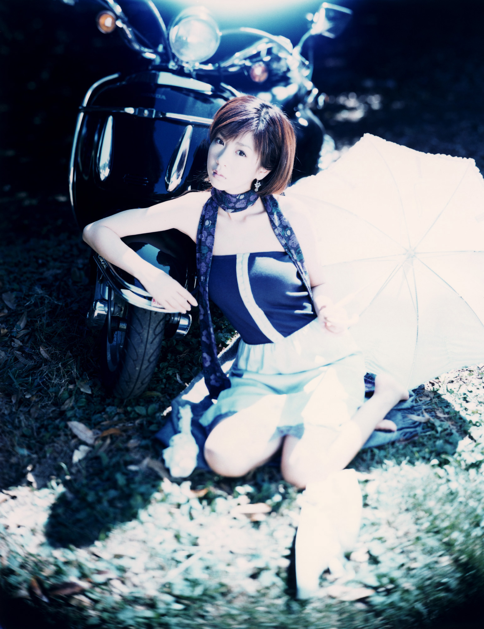 hoshino aki, vehicle, highres, photo (medium), 1girl, asian, dress, female focus, japanese (nationality), motor vehicle, outdoors, scarf, scooter, solo, strapless, strapless dress