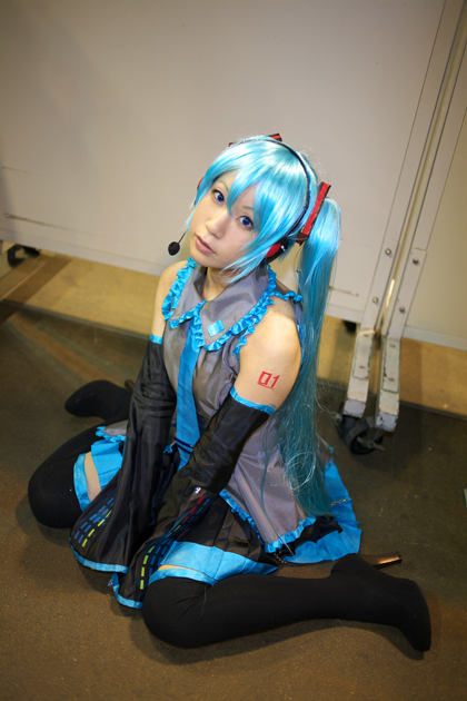 hatsune miku, vocaloid, photo (medium), 1girl, cosplay, detached sleeves, female focus, hatsune miku (cosplay), high heels, kanato akira, microphone, necktie, skirt, solo, tattoo, thighhighs, twintails
