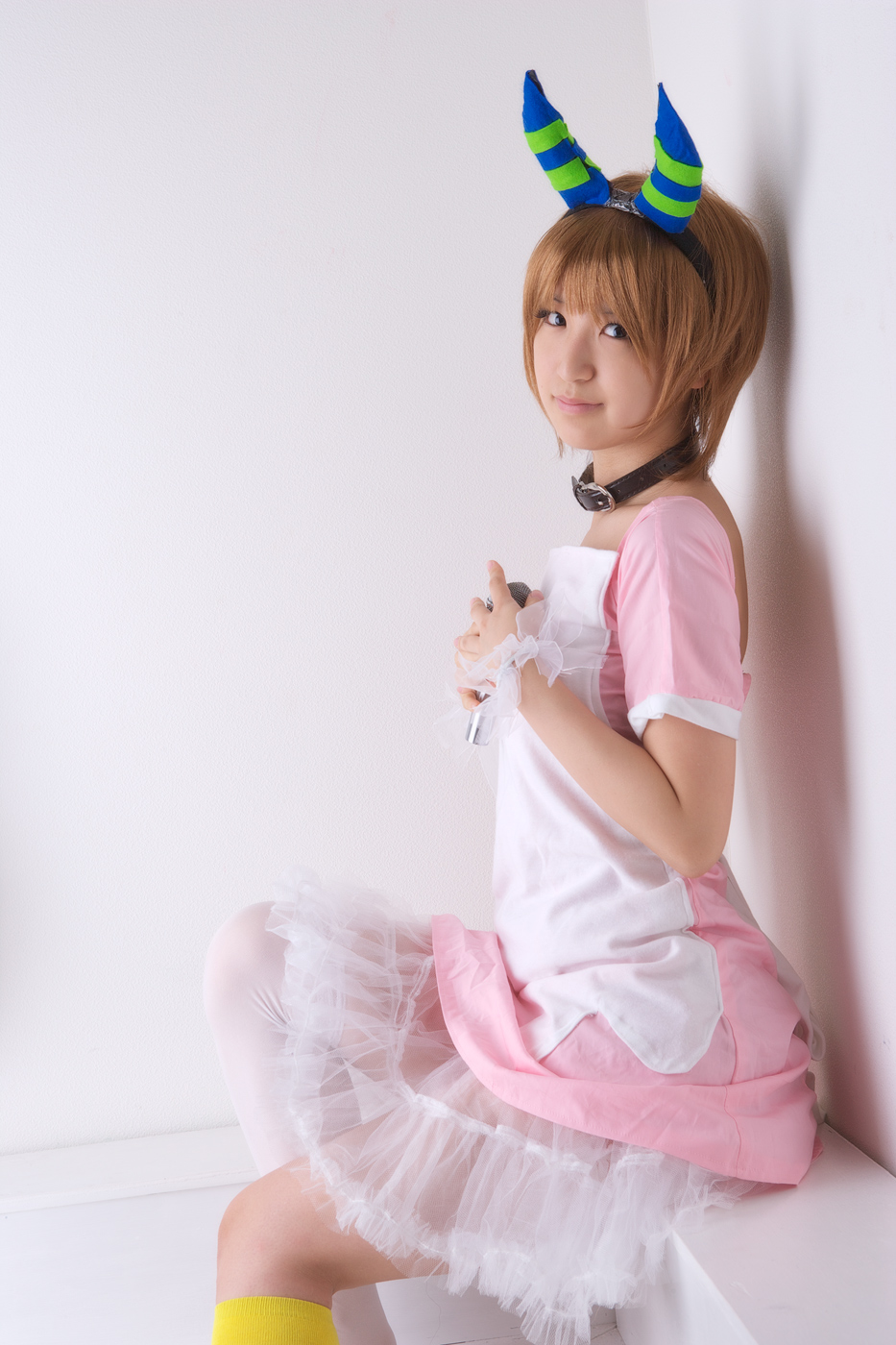 richi, linda (boku to maou), boku to maou, striped, highres, photo (medium), apron, black eyes, bob cut, brown hair, collar, cosplay, dress, hairband, horns, kneehighs, lipstick, makeup, microphone, pink lips, see-through clothes, shadow, short hair, single kneehigh, single sock, single thighhigh, sitting, smile, socks, solo, thighhighs, white socks