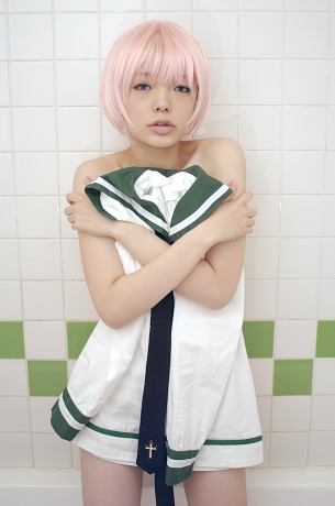namada, simca, air gear, lowres, photo (medium), 1girl, asian, bath, bob cut, clothes cover, cosplay, covering body, covering with clothes, cowboy shot, cross, facing viewer, female focus, indoors, japanese (nationality), looking at viewer, nude, parted lips, pink hair, sailor, school uniform, serafuku, short hair, solo, standing, tile wall, tiles, unworn clothes