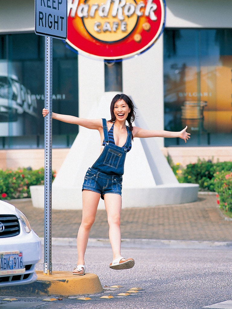 nagasawa nao, hard rock cafe, photo (medium), 1girl, asian, bare legs, bikini, bikini top only, bikini under clothes, blurry, braid, breasts, car, denim, depth of field, license plate, logo, long hair, looking at viewer, medium breasts, motor vehicle, outdoors, outstretched arms, overall shorts, overalls, road sign, sandals, sidewalk, sign, smile, standing, standing on one leg, striped bikini, striped clothes, swimsuit, twin braids
