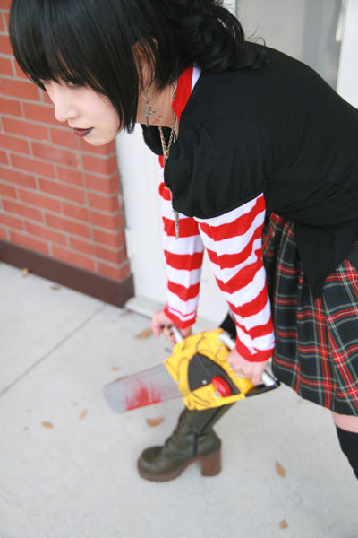 omi gibson, frederica sawyer, black lagoon, striped, photo (medium), 1girl, asian, boots, chainsaw, cosplay, female focus, frederica sawyer (cosplay), goth fashion, lace-up boots, plaid clothes, plaid skirt, pleated skirt, punk, skirt, thighhighs