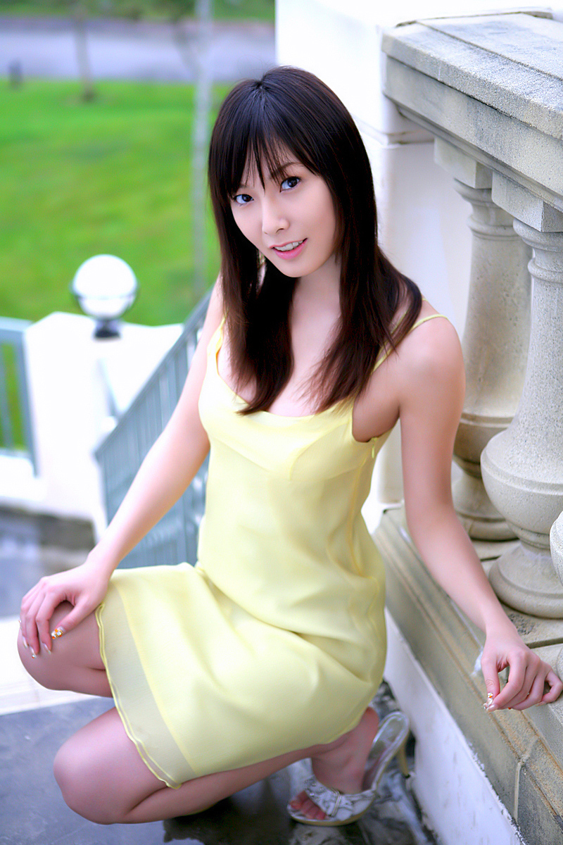 nagasawa nao, nao mail, highres, photo (medium), tagme, 1girl, asian, bare legs, bare shoulders, blurry, depth of field, dress, female focus, full body, high heels, japanese (nationality), long hair, looking at viewer, open shoes, outdoors, solo, spaghetti strap, squatting, stairs, sundress, yellow dress