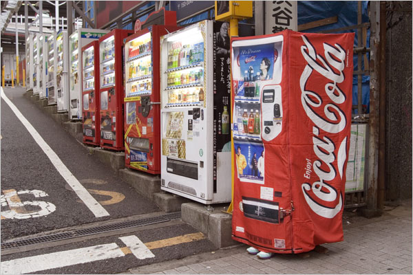 tsukioka aya, coca-cola, real life, blue footwear, cosplay photo, photo (medium), asian, bottle, cosplay, day, outdoors, road, shoes, standing, street, vending machine, what