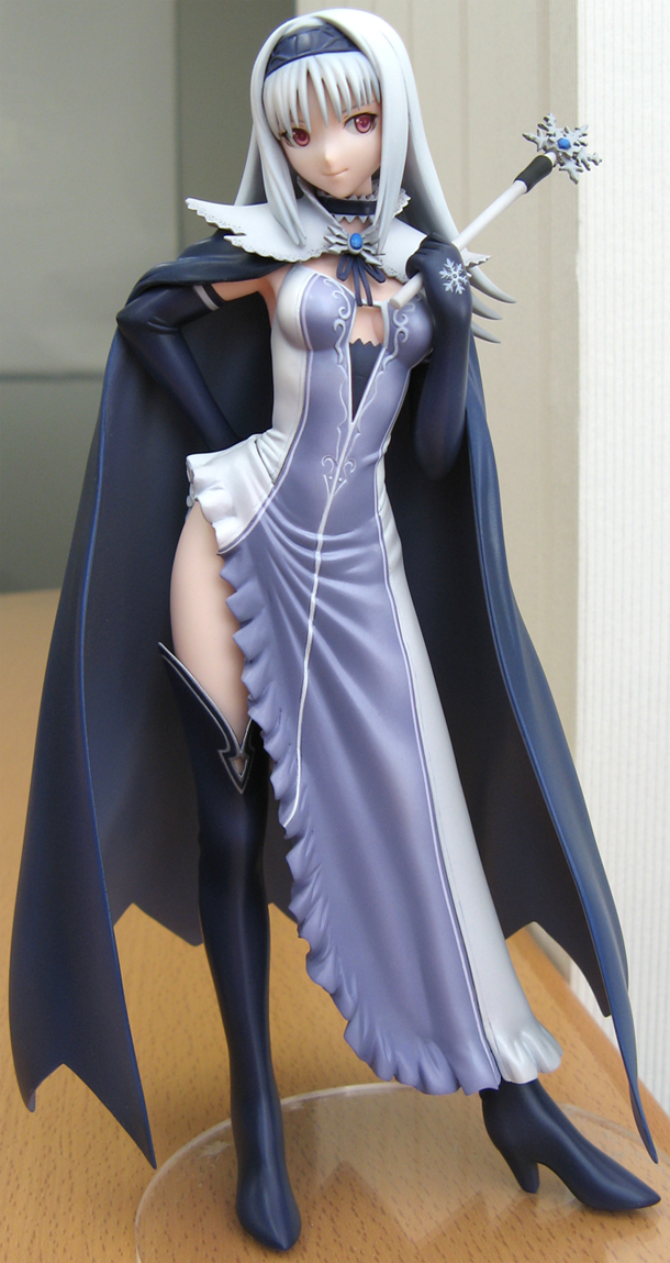 tony taka, blanc neige, sega, shining (series), shining tears, photo (medium), 1girl, armpits, black boots, black thighhighs, blue gemstone, boots, breasts, breasts apart, cape, cleavage, dress, elbow gloves, female focus, figure, figure (medium), full body, gem, gloves, hairband, hand on own hip, high collar, high heel boots, high heels, indoors, leaning to the side, legs apart, narrow waist, no bra, parted bangs, red eyes, shoes, solo, standing, thigh boots, thighhighs, wand, white hair