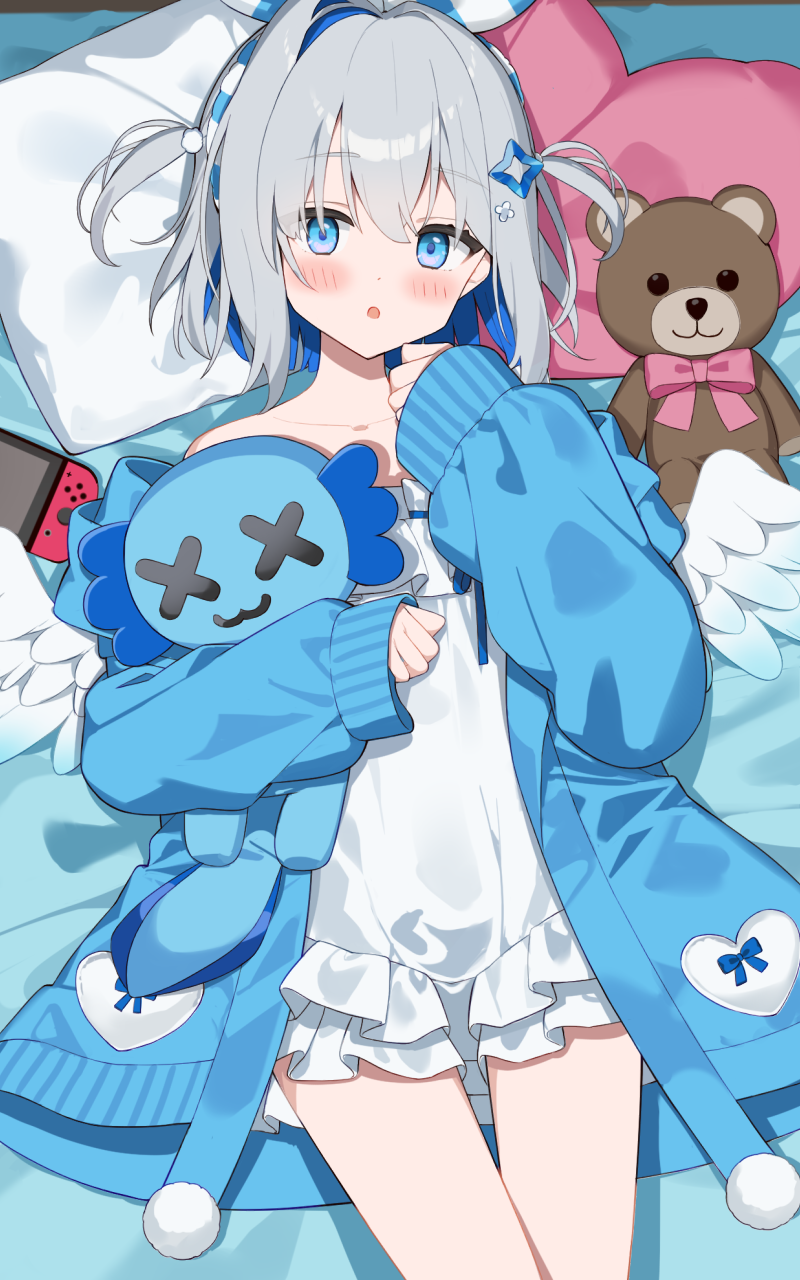 yoru no yayoi, amane kanata, upao (amane kanata), hololive, commentary request, highres, 1girl, :o, alternate costume, bed sheet, blue coat, blue eyes, blue hair, blush, coat, colored inner hair, dress, grey hair, heart, heart-shaped pillow, looking at viewer, lying, multicolored hair, nintendo switch, off shoulder, on back, pillow, short hair, solo, stuffed animal, stuffed toy, teddy bear, two side up, virtual youtuber, white dress, white wings, wings